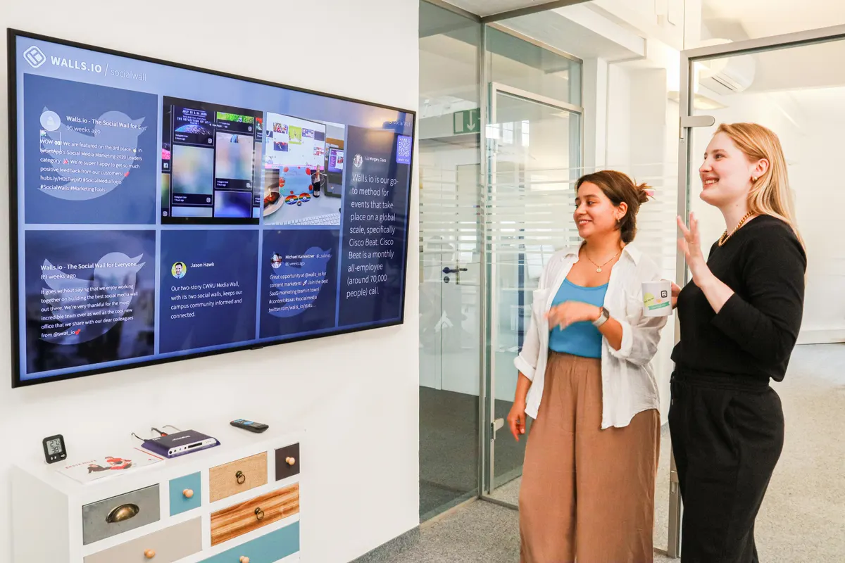 A team collaborating around a Samsung display in a meeting room